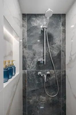 a bathroom with a shower with a shower head at 60 Loft in Vilnius