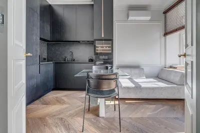 a kitchen with a table and chairs in a room at New! Luxury Old town apartment in Vilnius