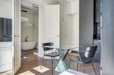 a dining room with a glass table and two chairs at New! Luxury Old town apartment in Vilnius