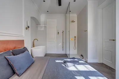 a bedroom with a bed and a bathroom with a tub at New! Luxury Old town apartment in Vilnius