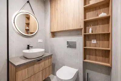 a bathroom with a sink and a toilet and a mirror at Luxury apartment near downtown in Vilnius