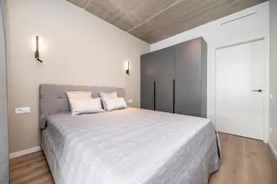 a bedroom with a large bed in a room at Luxury apartment near downtown in Vilnius
