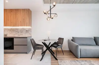 a living room with a table and a couch at Luxury apartment near downtown in Vilnius