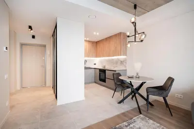 a kitchen and dining room with a table and chairs at Luxury apartment near downtown in Vilnius