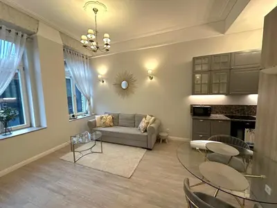 a living room with a couch and a table at Apartamentai Bazilijonai in Vilnius