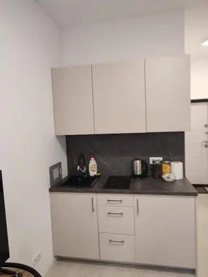 a white kitchen with white cabinets and appliances at GoodStopCenter in Vilnius