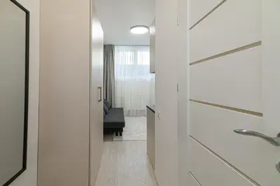 a bathroom with white walls and a sliding door at ShortStopStudent in Vilnius