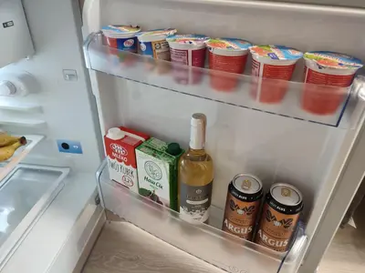 an open refrigerator filled with food and drinks at ShortStopStudent in Vilnius