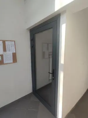 a glass door in a room with a wall at ShortStopStudent in Vilnius