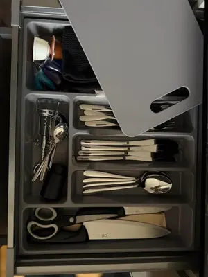 a drawer filled with utensils and a laptop at Small but with character in Kaunas