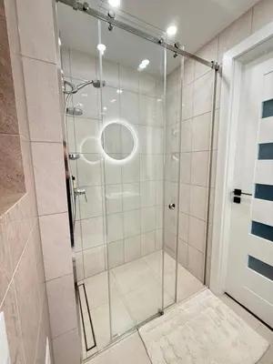 a shower with a glass door in a bathroom at Small but with character in Kaunas