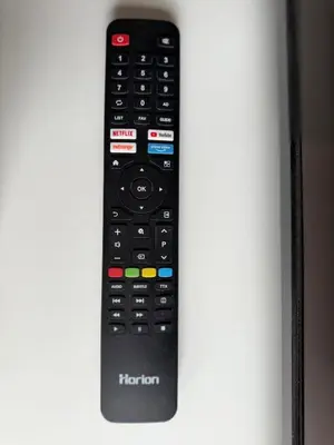 a black remote control sitting on top of a shelf at Small but with character in Kaunas