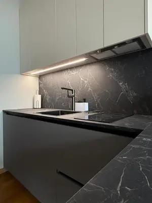 a kitchen with a black counter top and a sink at Small but with character in Kaunas