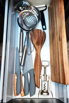 a group of kitchen utensils sitting on a shelf at Elumen Studio Apartment I near Cathedral & Bernardine Park in Vilnius