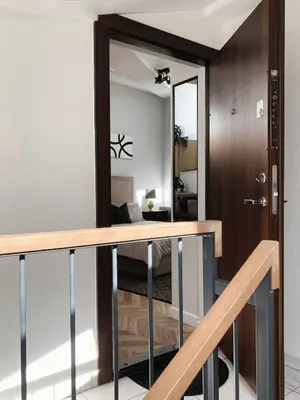 a room with a mirror and a bed in a room at Elumen Studio Apartment I near Cathedral & Bernardine Park in Vilnius