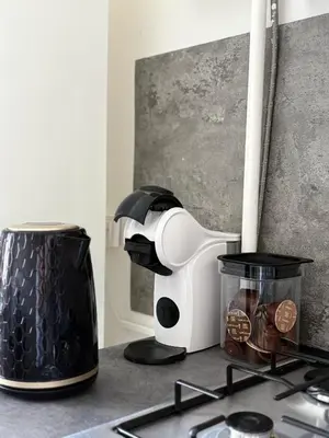 a kitchen counter with a coffee maker and a blender at Apartamentai Jonavoje #2 in Jonava