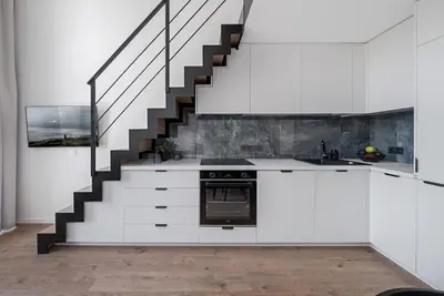 a kitchen with white cabinets and a staircase at Loft 60 with Free parking in Vilnius