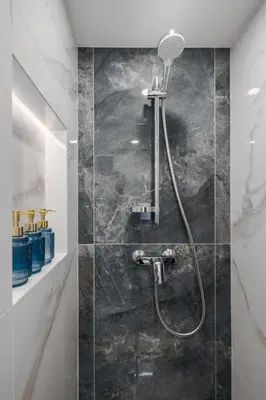 a bathroom with a shower with a shower head at Loft 60 with Free parking in Vilnius