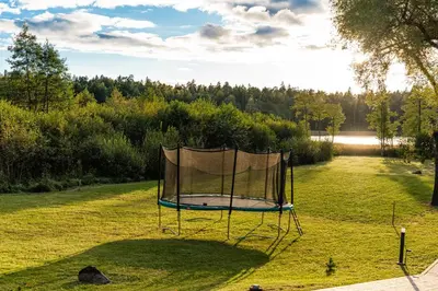 a basketball hoop in the middle of a field at Namas su vaizdu į ežerą 