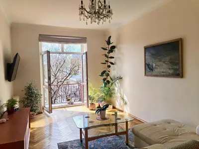 a living room with a coffee table and a window at Heart of Kaunas Apartament in Kaunas