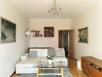 a living room with a white couch and a table at Heart of Kaunas Apartament in Kaunas