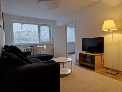 a living room with a couch and a flat screen tv at Close to Park in Kaunas