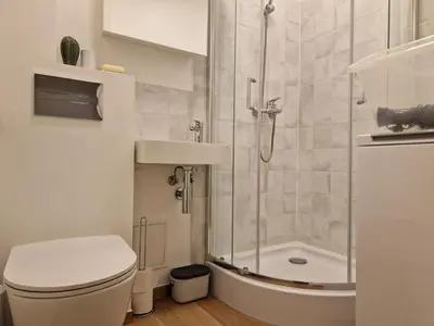 a bathroom with a shower and a toilet and a sink at Close to Park in Kaunas