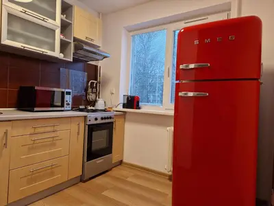 a red refrigerator in a kitchen with a window at Close to Park in Kaunas