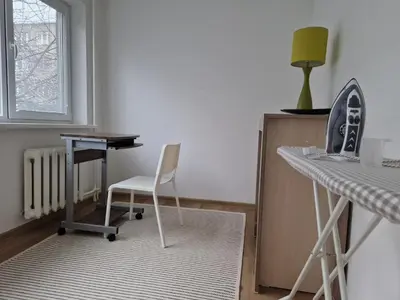 a room with a desk and a chair and a table at Close to Park in Kaunas