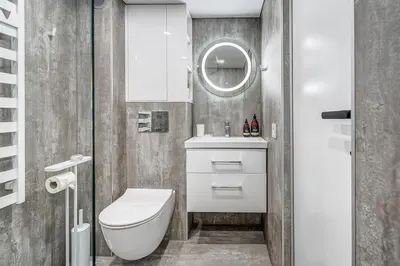 a bathroom with a toilet and a sink and a mirror at Modern Studio near the city center in Vilnius