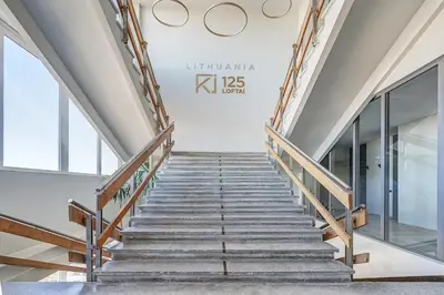 a staircase in a building with glass windows at Modern Studio near the city center in Vilnius