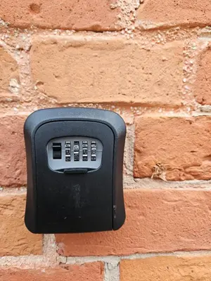 a black soap dispenser on a brick wall at Loft in Freda in Kaunas