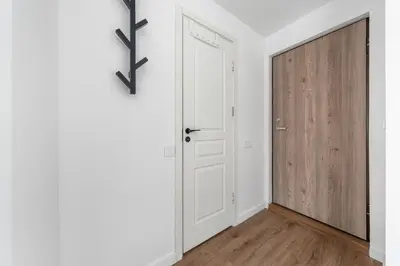 an empty hallway with a door and white walls at Bright, cozy apartment 5 min walk to Old town in Vilnius