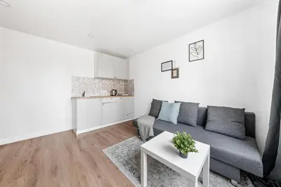 a living room with a couch and a table at Bright, cozy apartment 5 min walk to Old town in Vilnius
