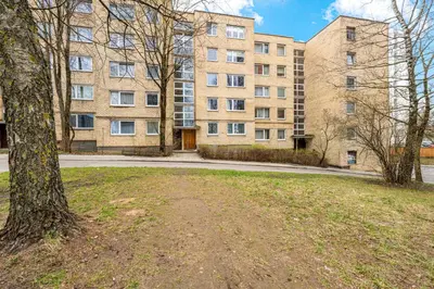 an empty park in front of a large building at Bright, cozy apartment 5 min walk to Old town in Vilnius