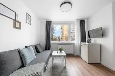 a living room with a couch and a table at Bright, cozy apartment 5 min walk to Old town in Vilnius