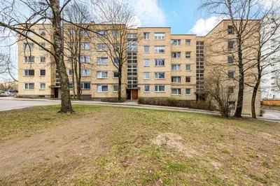 an empty field in front of a large building at Bright, cozy apartment 5 min walk to Old town in Vilnius