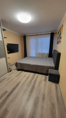 a bedroom with a bed and a large window at Patogus poilsis in Ignalina