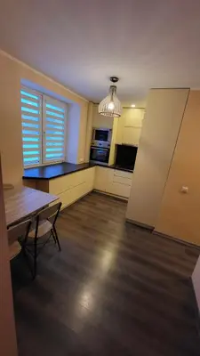 an empty kitchen with a table and a dining room at Patogus poilsis in Ignalina