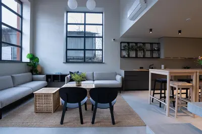 a living room with a couch and a table and chairs at citywave Vilnius in Vilnius