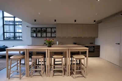 a kitchen with a large island with stools at citywave Vilnius in Vilnius
