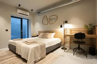 a bedroom with a bed and a chair in it at citywave Vilnius in Vilnius