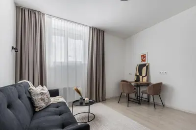 a living room with a couch and a table at Fox Rock Studio - Self check in in Vilnius
