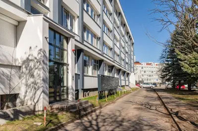 an empty street in front of a building at Fox Rock Studio - Self check in in Vilnius