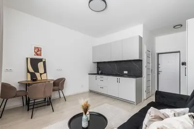 a living room with a couch and a table at Fox Rock Studio - Self check in in Vilnius