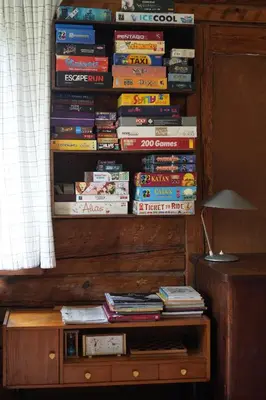 a stack of books sitting on top of a book shelf at Molinis ir Medinis in Ažuluokesa