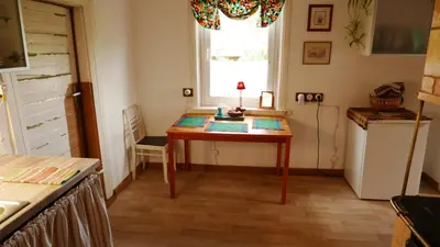 a small room with a table and a window at Namelis 1954 in Švenčionėliai