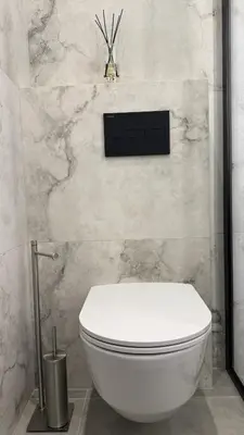 a white toilet in a bathroom with a wall at EVA boutique apartments in Vilnius