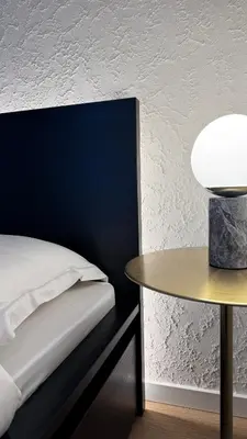 a bedroom with a bed and a table at EVA boutique apartments in Vilnius
