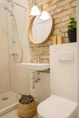 a bathroom with a sink and a mirror and a toilet at Lukiškės Central Apartment - Self Check-in and Parking Option in Vilnius